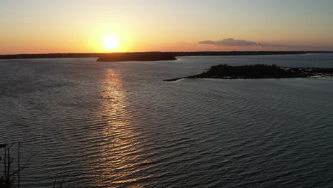 aerial shot of the salt marsh or wetlands, cinematic drone shot into the sun