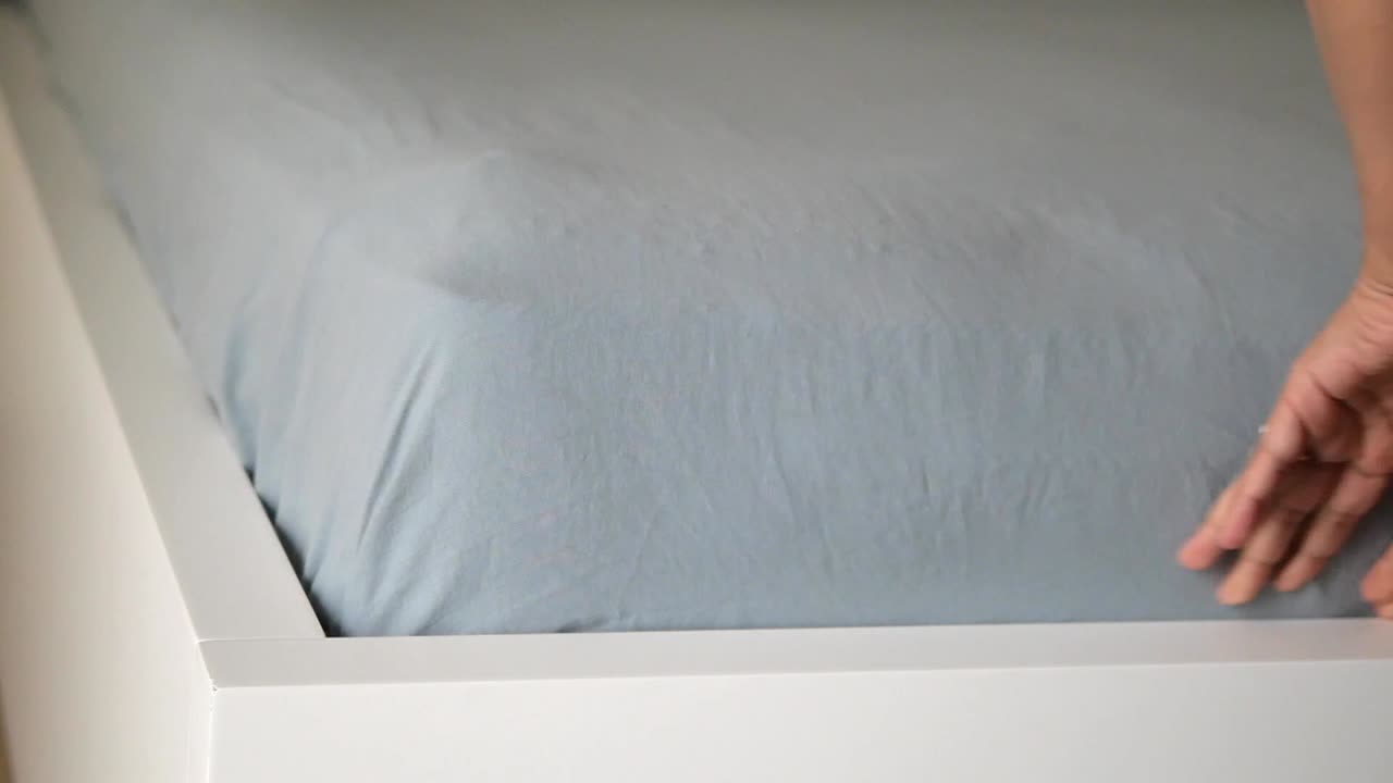 Making a bed with clean sheets