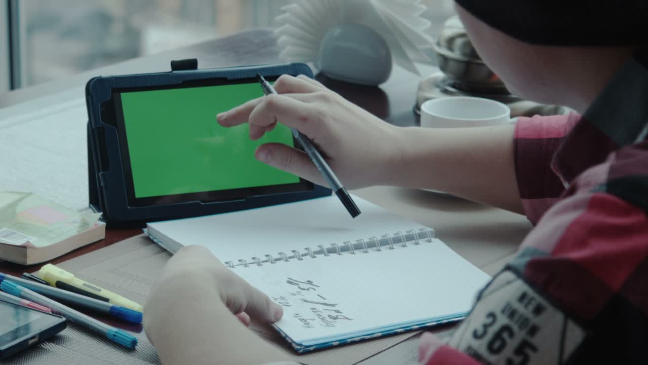 Freelancer Using Laptop while Working in Cafe at Table