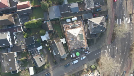 Top-down-aerial-of-house-rooftop-under-construction---drone-setting-down-and-spinning