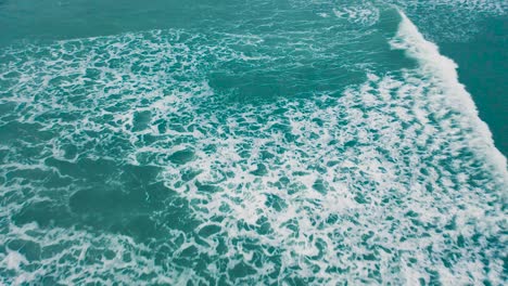 Waves-crashing-over-the-beach-during-sunset