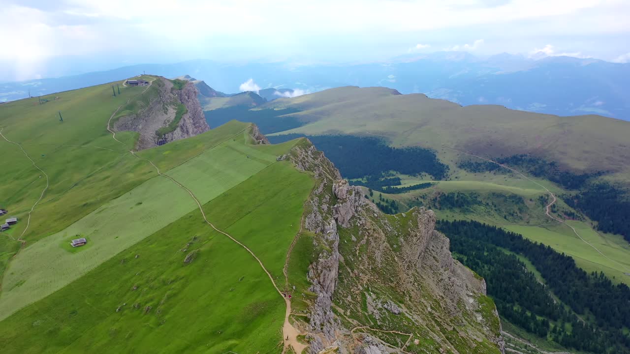 Seceda mountain ridge in the Dolomites in summer, forward aerial