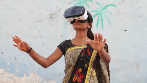 young teenager girl wearing vr virtual reality headset working games enjoy music playing engage cinema film hands point cutting edge contemporary wireless communication technology surreal india rural