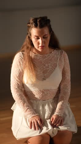 woman kneeling in white dress