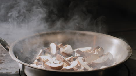 mushrooms being sautéed in a hot pan