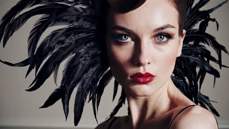 woman with black feathered headpiece and red lips