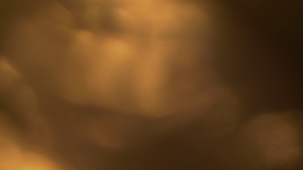 Transizione astratta con fughe di luce calde e bokeh