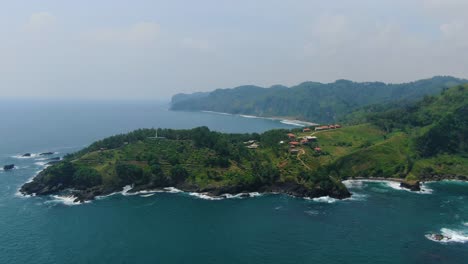 Volcanic-cape-at-Menganti-Kebumen-beach-at-Java-coast-Indonesia,-aerial-panorama