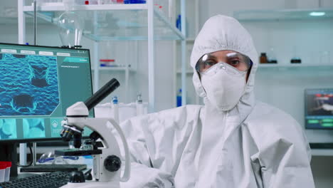 tired laboratory doctor with overall suit looking at camera