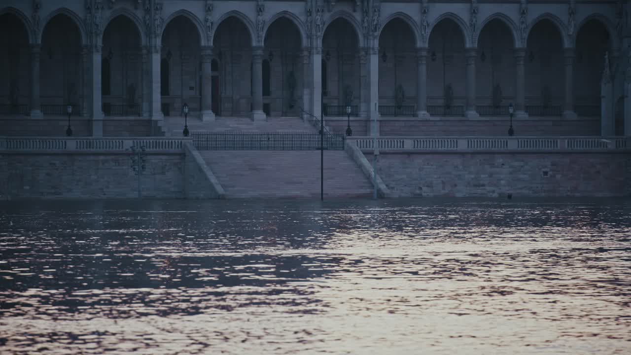 Water submerges the steps leading to Budapest’s Parliament, leaving only arches visible