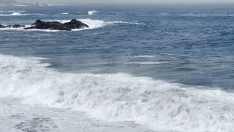 big powerful waves crashing at the shore on a sunny day in tenerife