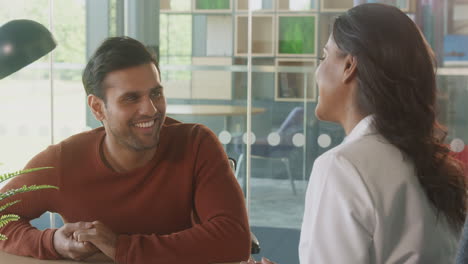 Female-Doctor-In-Office-Having-Meeting-With-Male-Patient-In-Wheelchair-In-Hospital