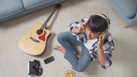 young man listening to music at home