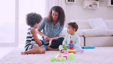 young black mum playing with her daughter and toddler son