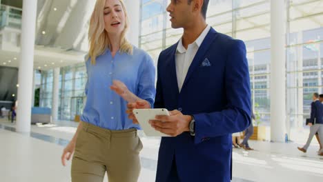 multi ethnic business people discussing over digital tablet in the lobby at office 4k