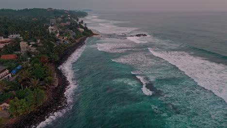 stunning aerial footage capturing the golden hues of sunset over the weligama coastline in sri lanka.