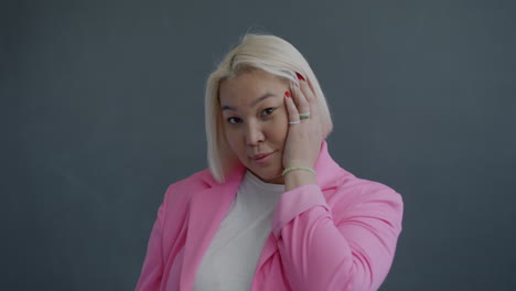 confident woman in pink blazer
