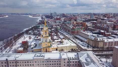 snowy cityscape with church and river view