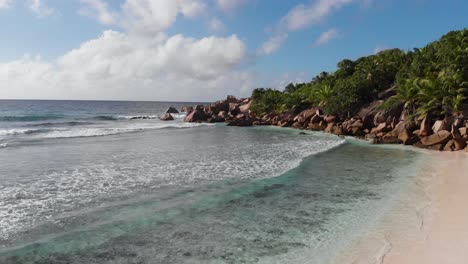 aerial view of the white beaches and turquoise waters at anse coco, petit anse and grand anse on la digue, an island of the seychelles