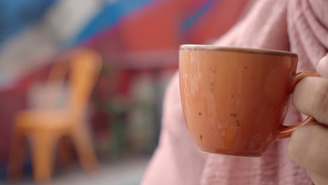 woman enjoying a hot drink outdoors