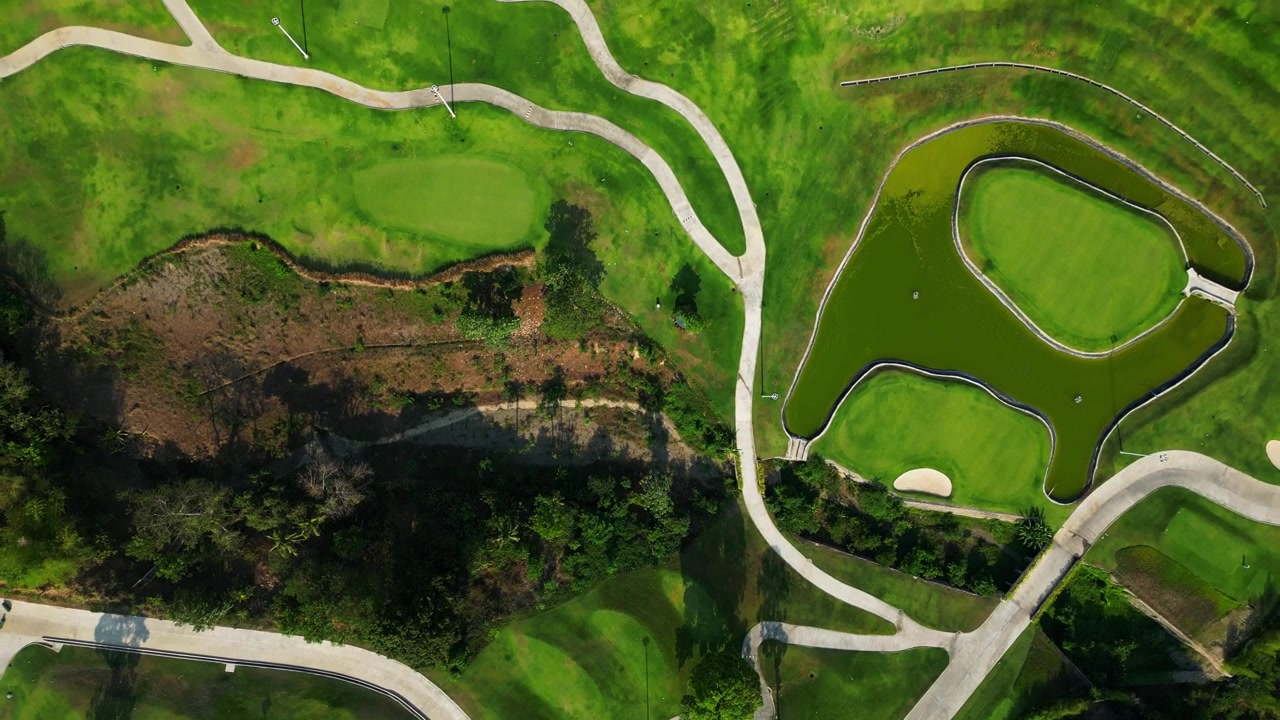 FPV flythrough above golf pathways in Tanauan City Batangas Philippines with lush greenery and cinematic tropical environment.