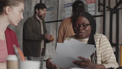 african employee looking through documents
