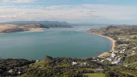 Aerial-drone-flying-sideways-towards-Omapere,-New-Zealand