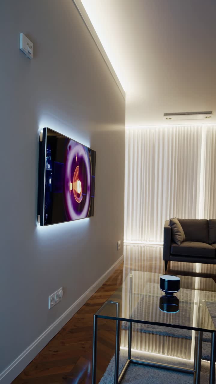 Modern living room with a wall-mounted TV displaying a video