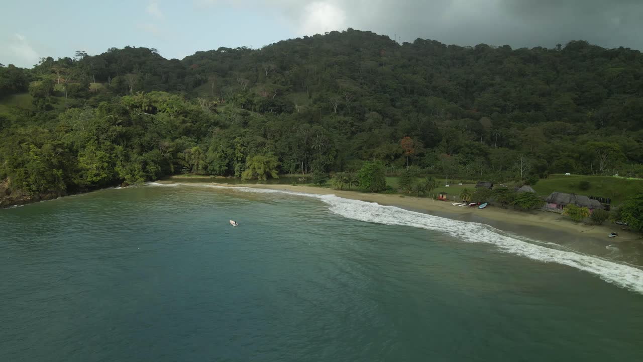Descending drone view of a lone fishing boat fishing in the waters of Bloody Bay, Tobago