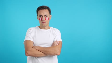 dignified and serious man with peruvian flag painted on face