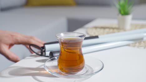 blind man drinking tea. close-up of tea and hands.