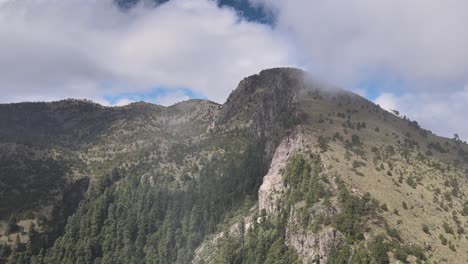 Jib-up-and-movement-to-left-above-mountain-in-a-foggy-day