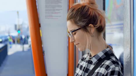 Woman-sitting-on-bus-stop-4k