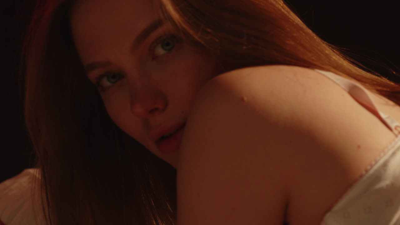 Sensual close up of an attractive Caucasian woman with stunning blue eyes looking at the camera