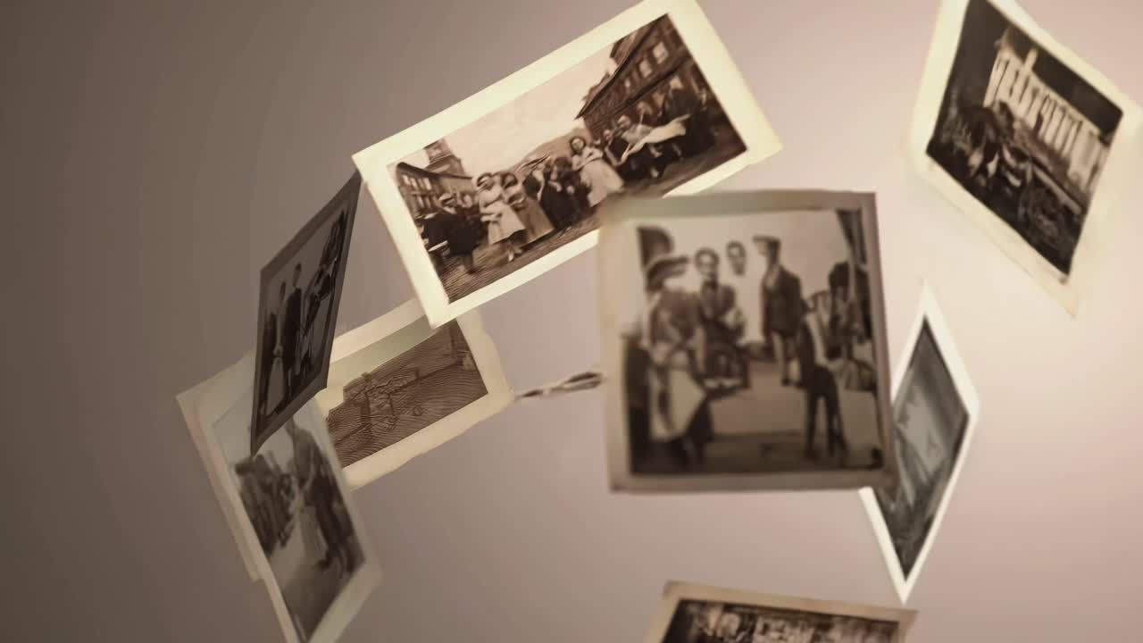 Vintage photos float mid-air against a neutral backdrop, captured from a dynamic angle