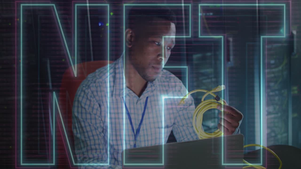 Animation of nft text over african american man using laptop in server room