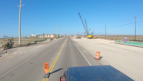 vista superior del techo del vehículo mientras conduce a través de la zona de construcción de carreteras en un día soleado