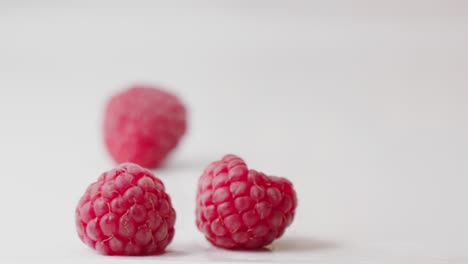 red wet raspberries falling down