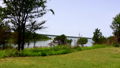 Static video of Lake Murray from Lake Murray State Park in Ardmore, Oklahoma. A scenic view with trees in the foreground and the lake in the background