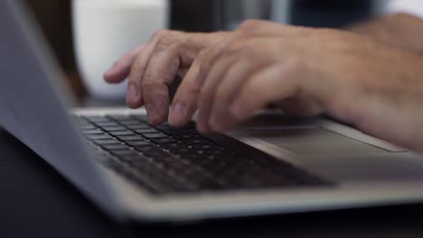 Adult businessman typing on laptop keyboard. Male blogger hands busy typing on computer to writing content or article to web