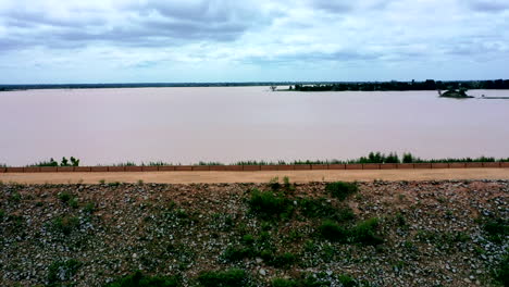 A-dirt-road-around-the-Ajiwa-Reservoir-in-Nigeria's-Katsina-State---sliding-aerial-view