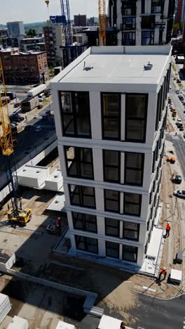 construction of a modern high-rise building in an urban environment