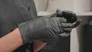 Caucasian Tattoo Artist Putting On Nitrile Gloves In Studio Closeup Of 