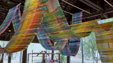 vibrant fabric weaving under a wooden structure