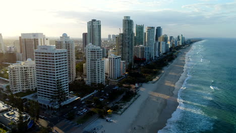 Fly-away-reveal-of-Surfers-Paradise,-at-golden-hour