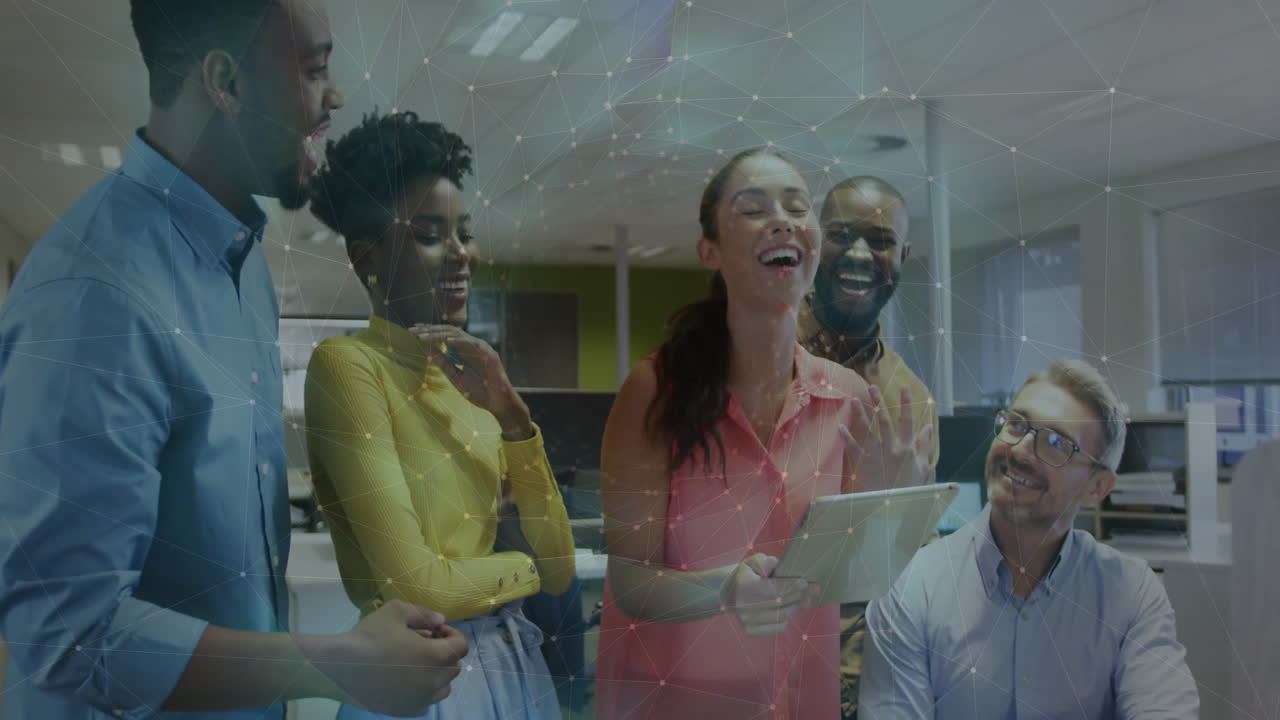 In office, colleagues discussing digital network connections and laughing together