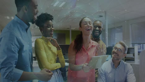 in office, colleagues discussing digital network connections and laughing together