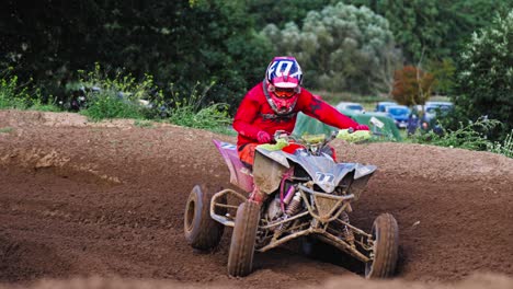 quad motorbike competitors turn on curvy dirt road on high speed in slow motion