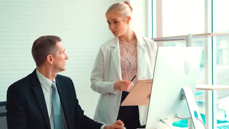 two business people talk project strategy at office