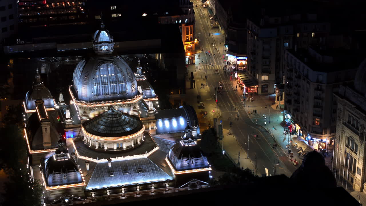 Aerial drone view of the Palace of the Deposits and Consignments illuminated in Bucharest, Romania at night